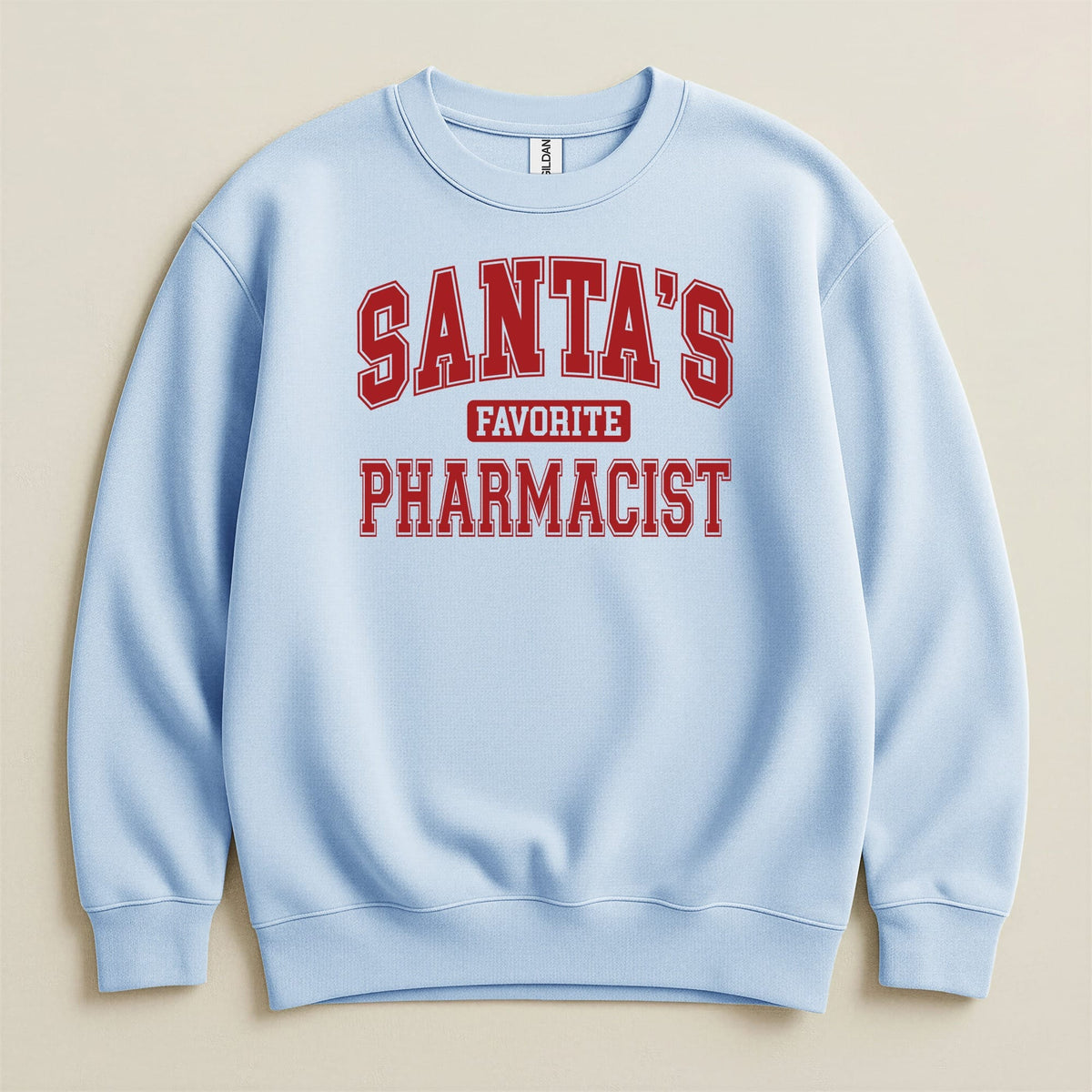 Light blue crewneck sweatshirt with red collegiate block lettering that reads SANTA'S FAVORITE PHARMACIST.