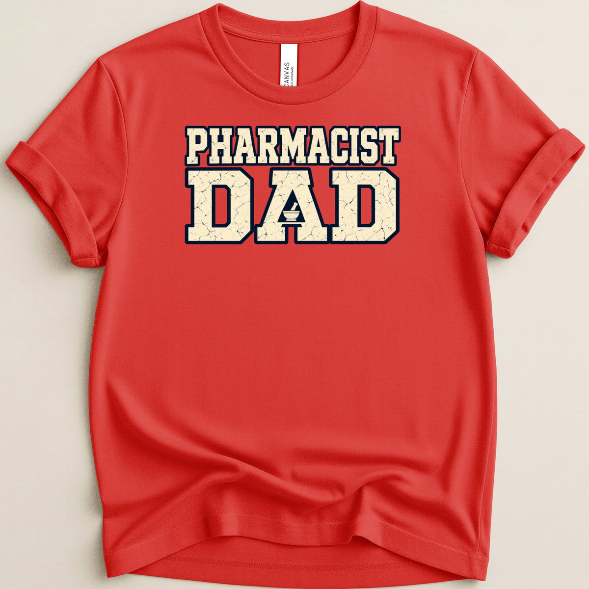 A red short-sleeve t-shirt with the words PHARMACIST DAD printed in distressed block letters across the chest.