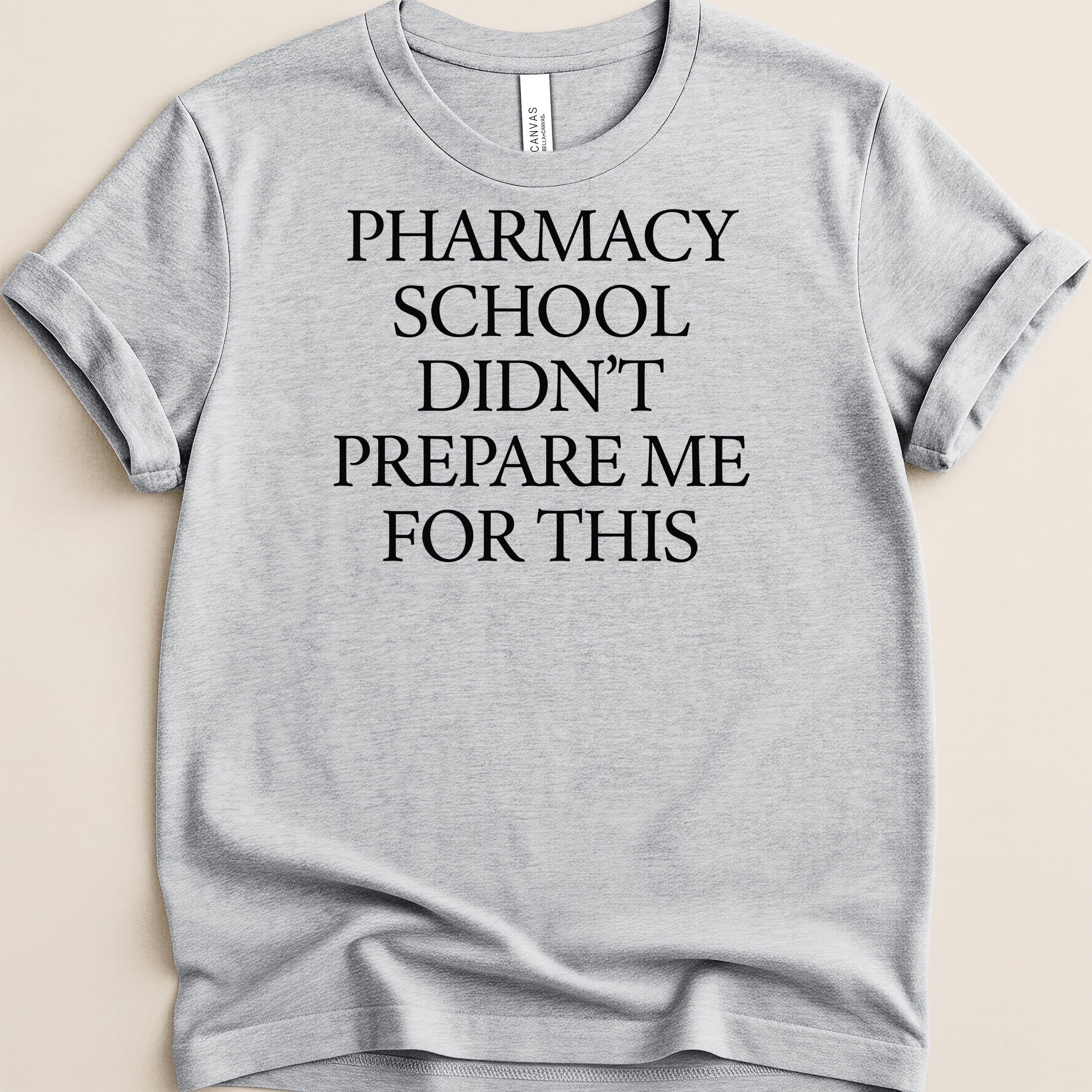 Gray t-shirt with "PHARMACY SCHOOL DIDN'T PREPARE ME FOR THIS" text.