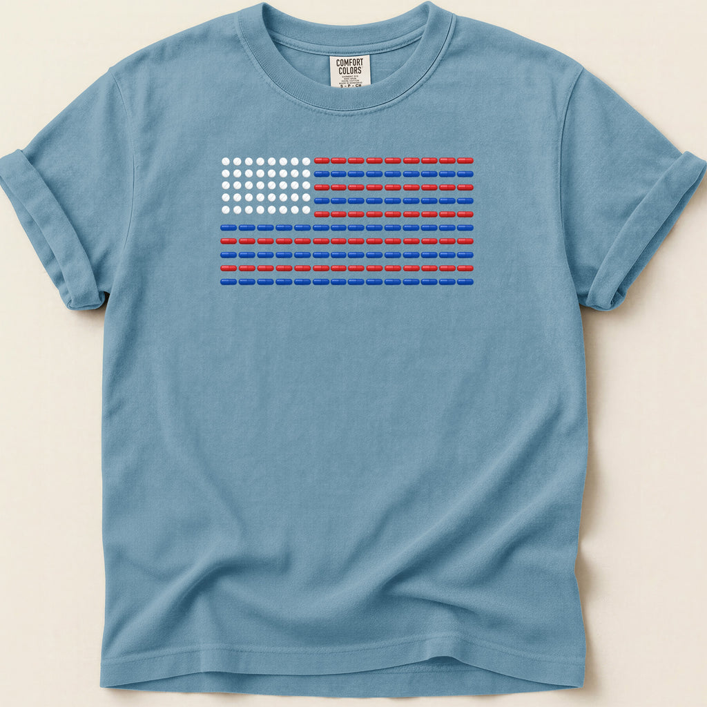 Blue t-shirt with American flag design made of red and white pills.