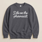 Charcoal crewneck sweatshirt with "Dibs on the pharmacist" text.