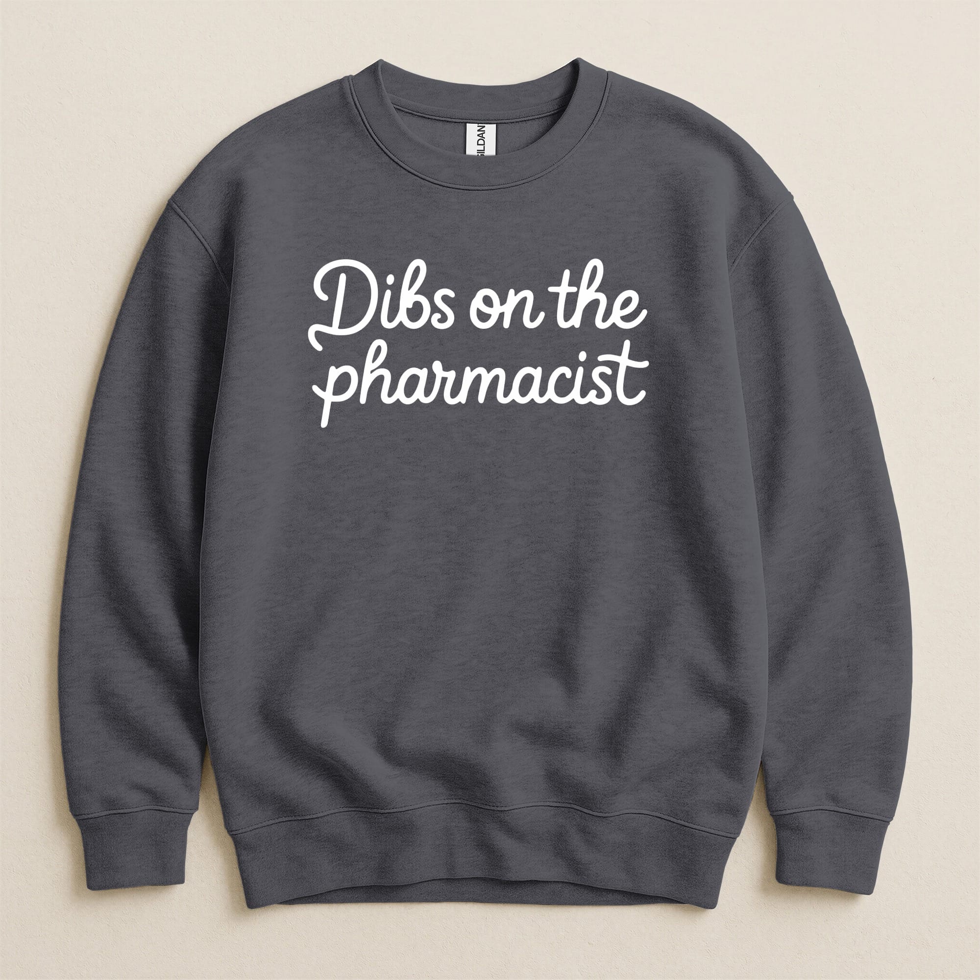 Charcoal crewneck sweatshirt with "Dibs on the pharmacist" text.