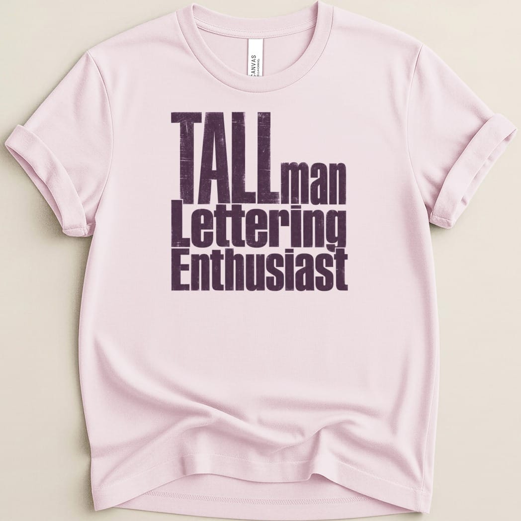 Pink t-shirt with distressed "Tallman Lettering Enthusiast" graphic text.