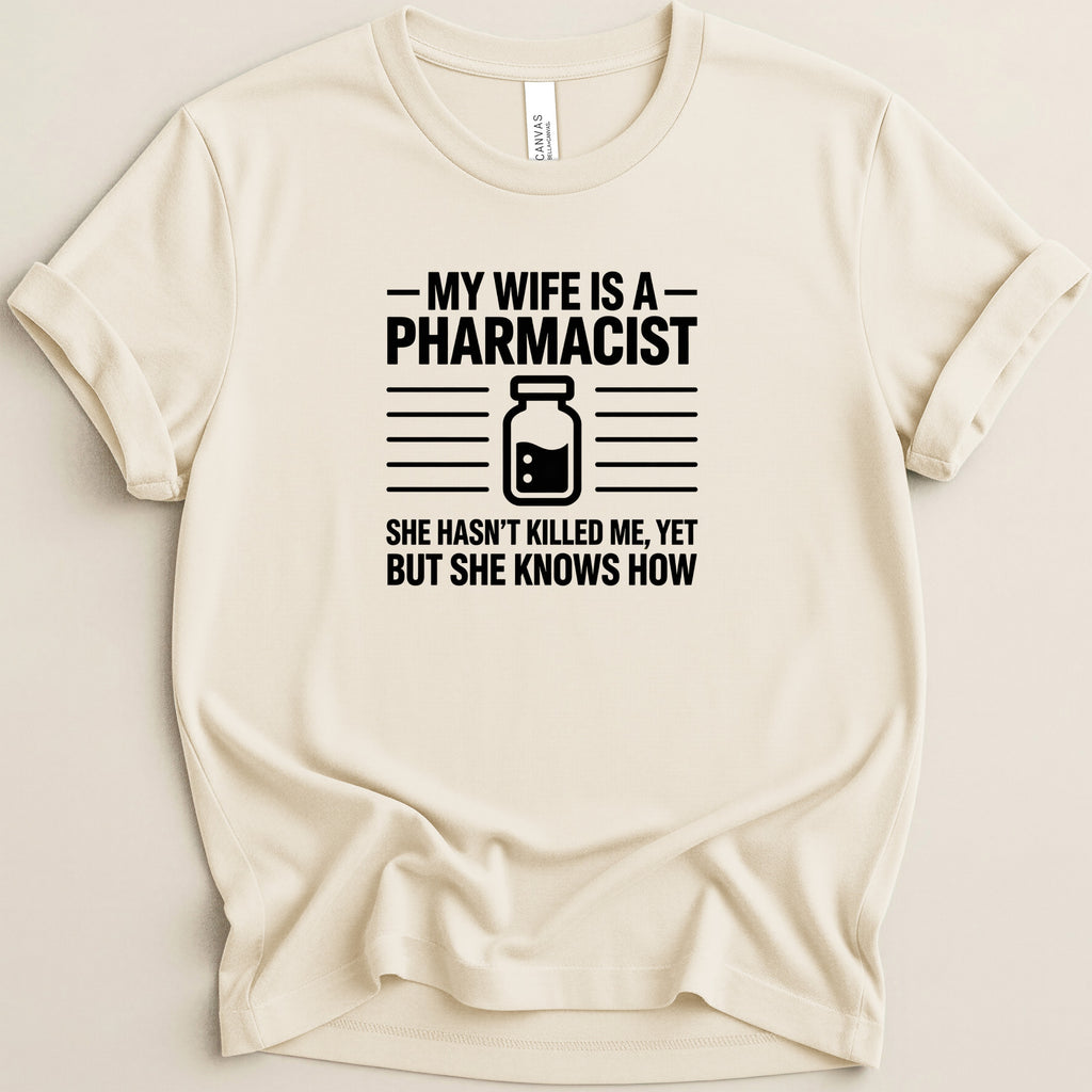 Cream t-shirt with black text: "My wife is a pharmacist. She hasn't killed me, yet but she knows how."
