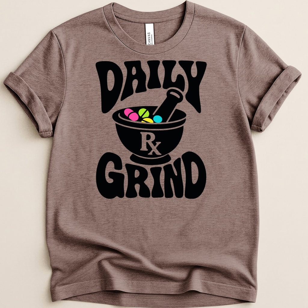 Brown t-shirt with black text "DAILY GRIND" and a mortar and pestle holding pills.