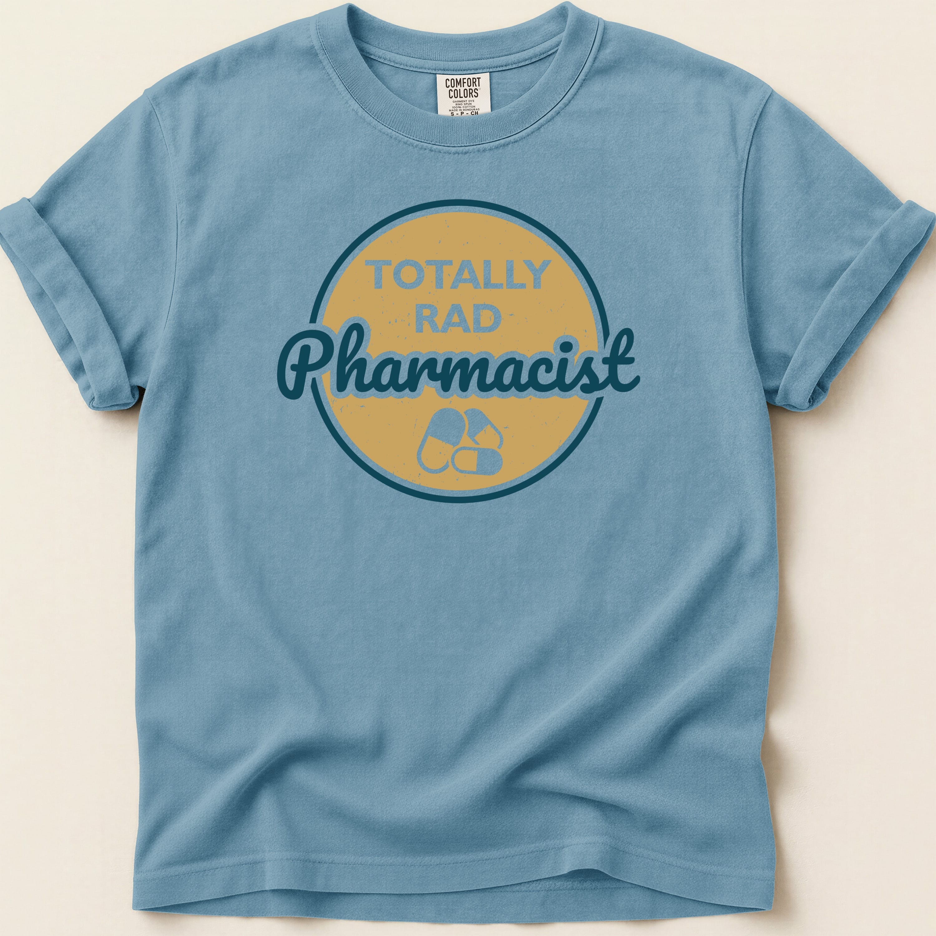 Blue t-shirt with "TOTALLY RAD Pharmacist" text and pill graphic.