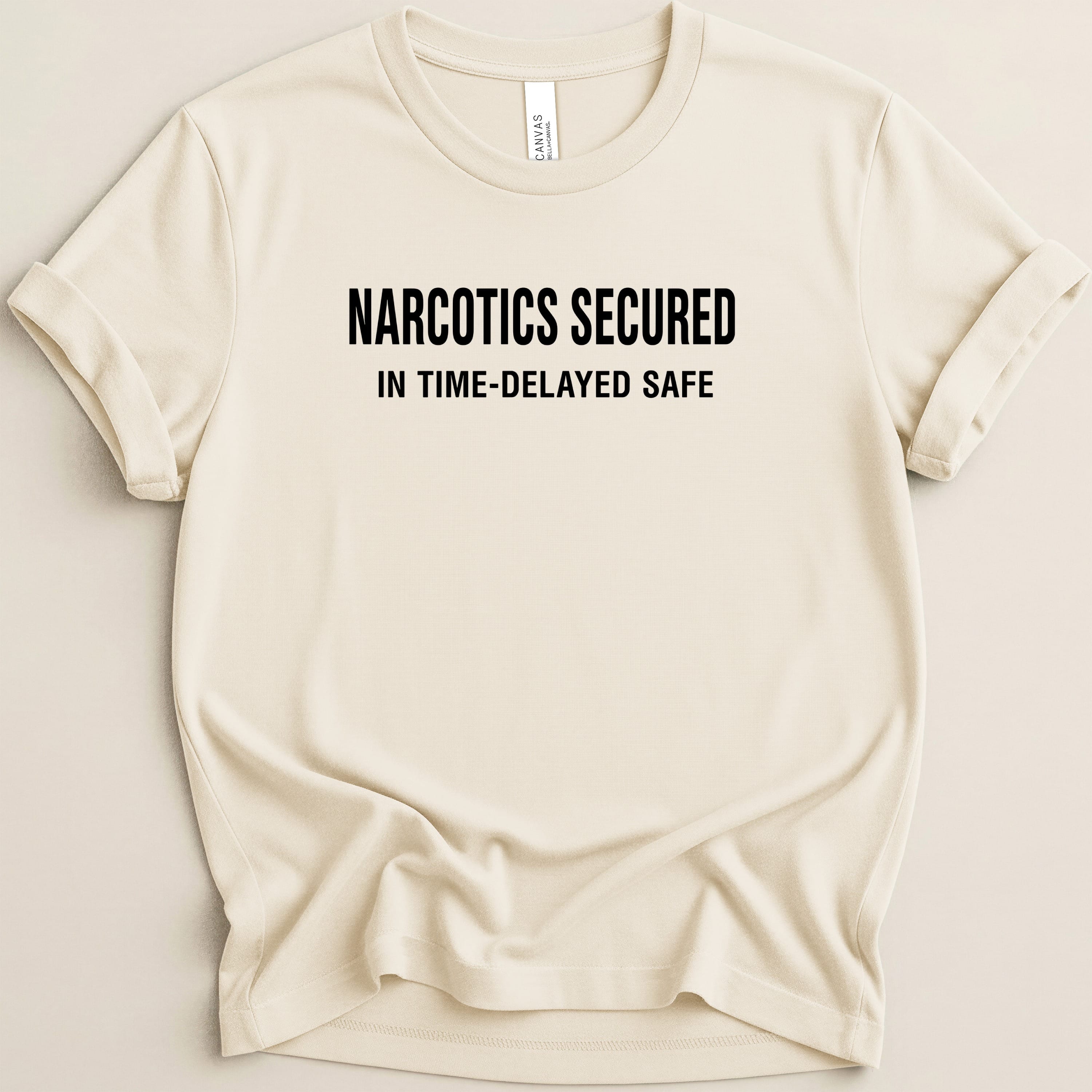 Cream t-shirt with black text: NARCOTICS SECURED IN TIME-DELAYED SAFE