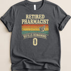 Dark t-shirt with "Retired Pharmacist Refills Remaining: 0" text and Rx mortar and pestle.
