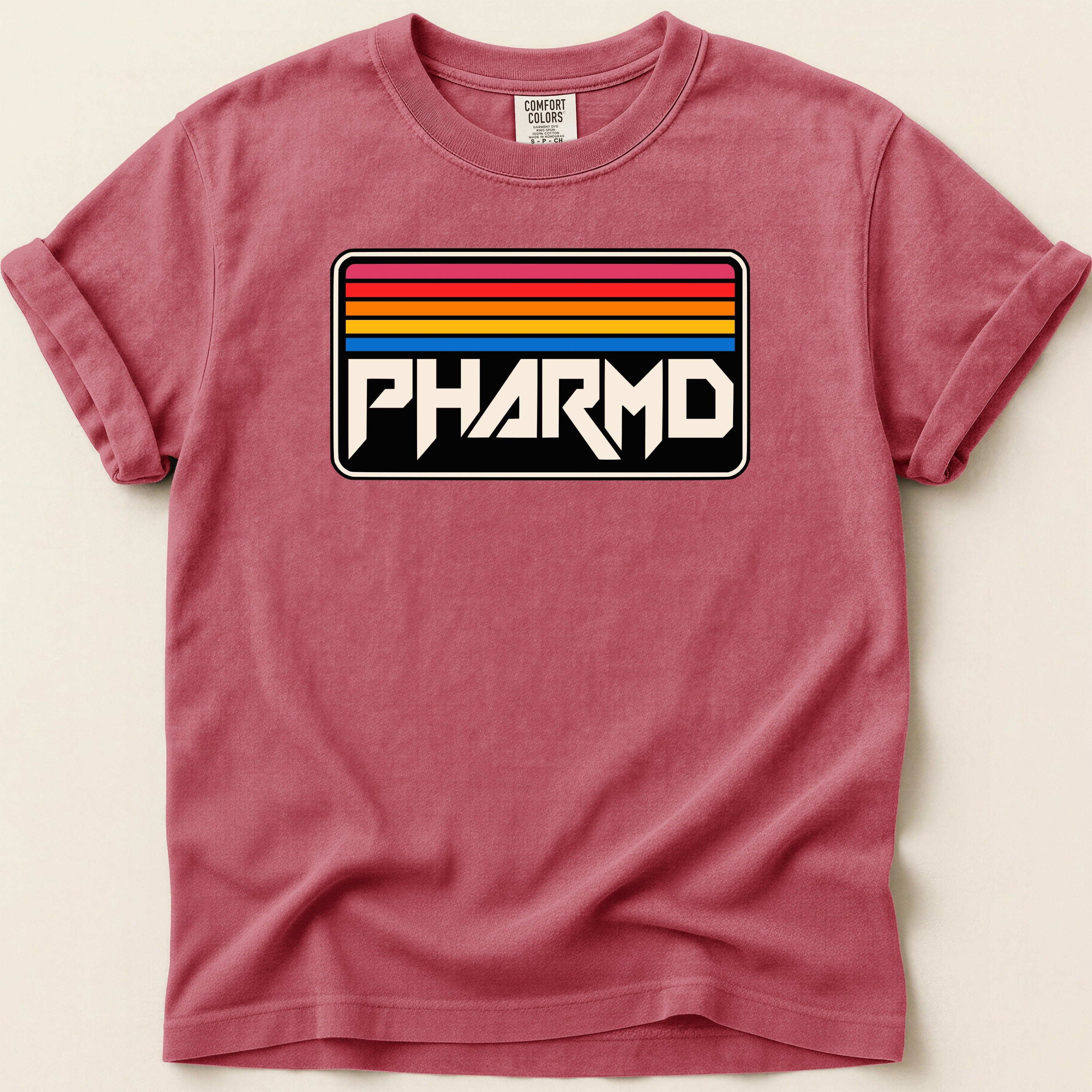 Red t-shirt with "PHARMD" in block letters on a retro, striped background.