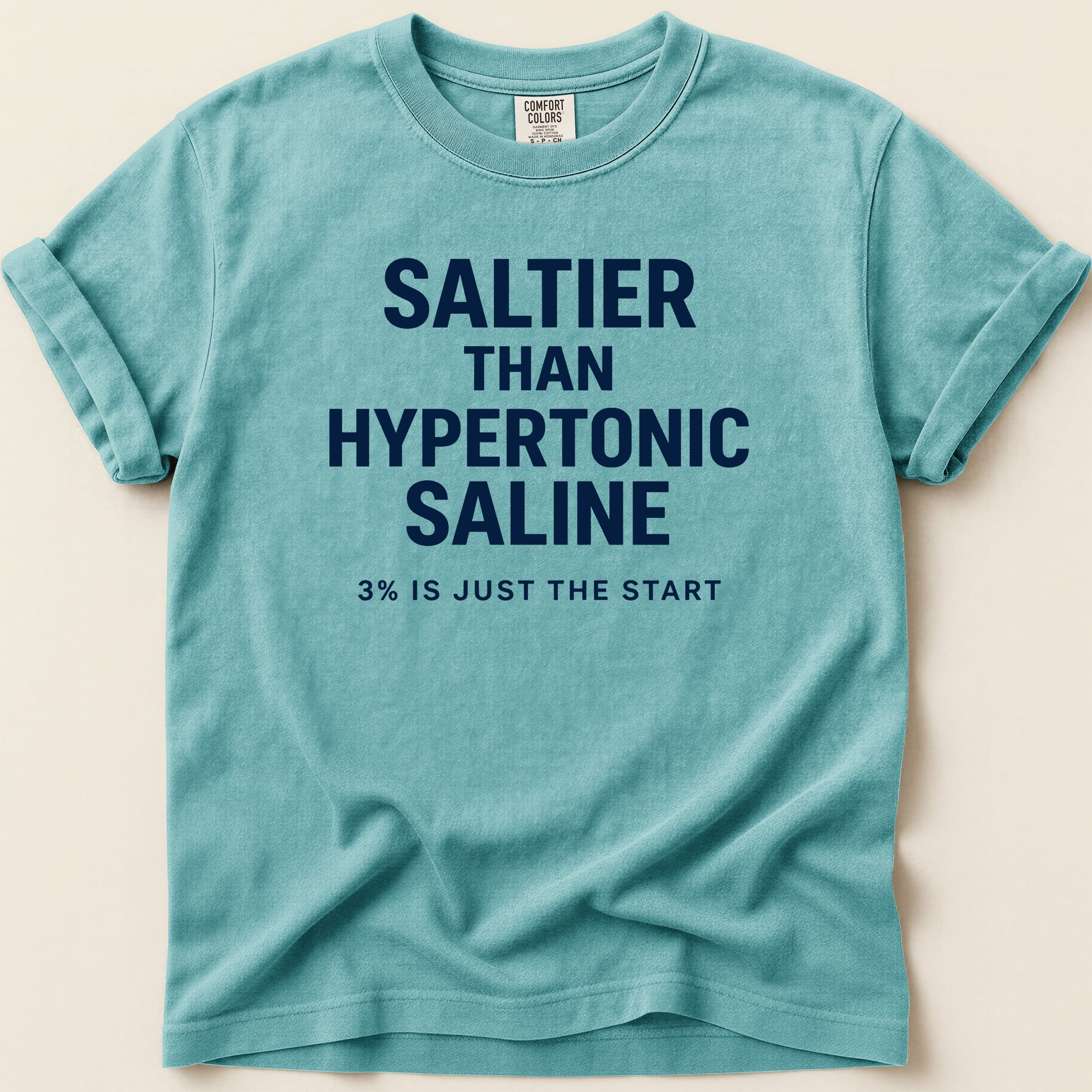 Teal t-shirt with "SALTIER THAN HYPERTONIC SALINE 3% IS JUST THE START" text.