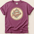 Purple t-shirt with "Support Your Local Druggist EST. 1920" circular graphic.