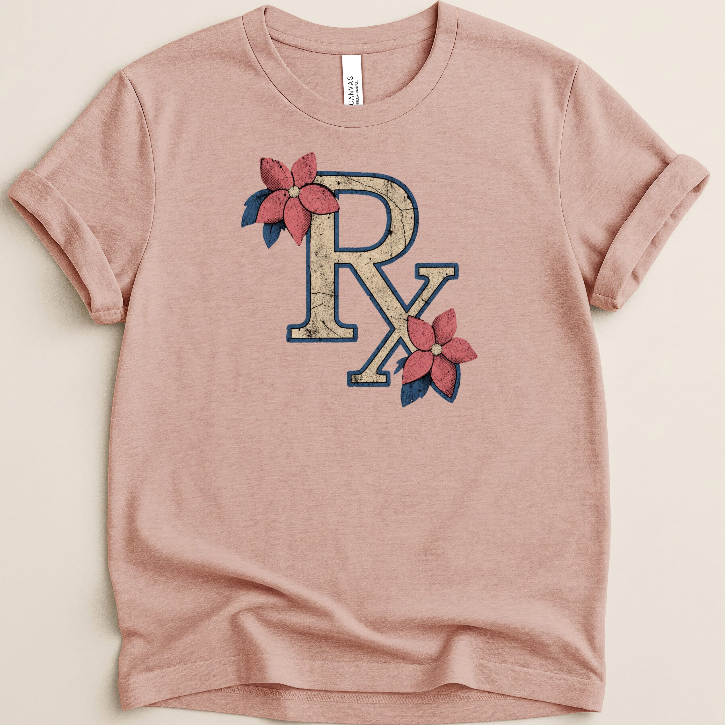 Pink t-shirt with a distressed "Rx" symbol and floral accents.