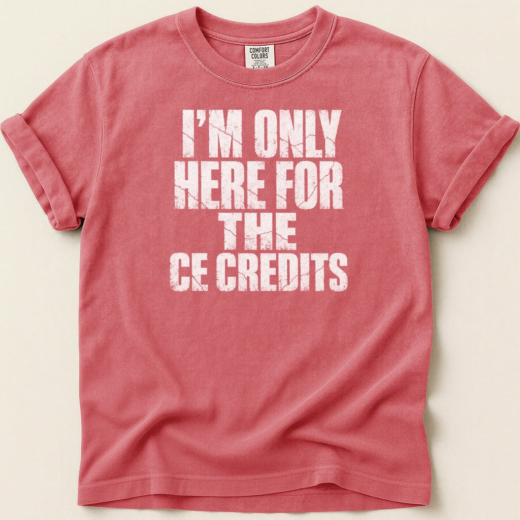 Coral t-shirt with white distressed text "I'M ONLY HERE FOR THE CE CREDITS".