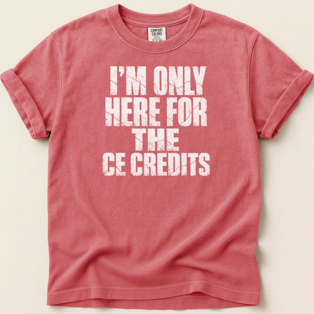 Coral t-shirt with white distressed text "I'M ONLY HERE FOR THE CE CREDITS".
