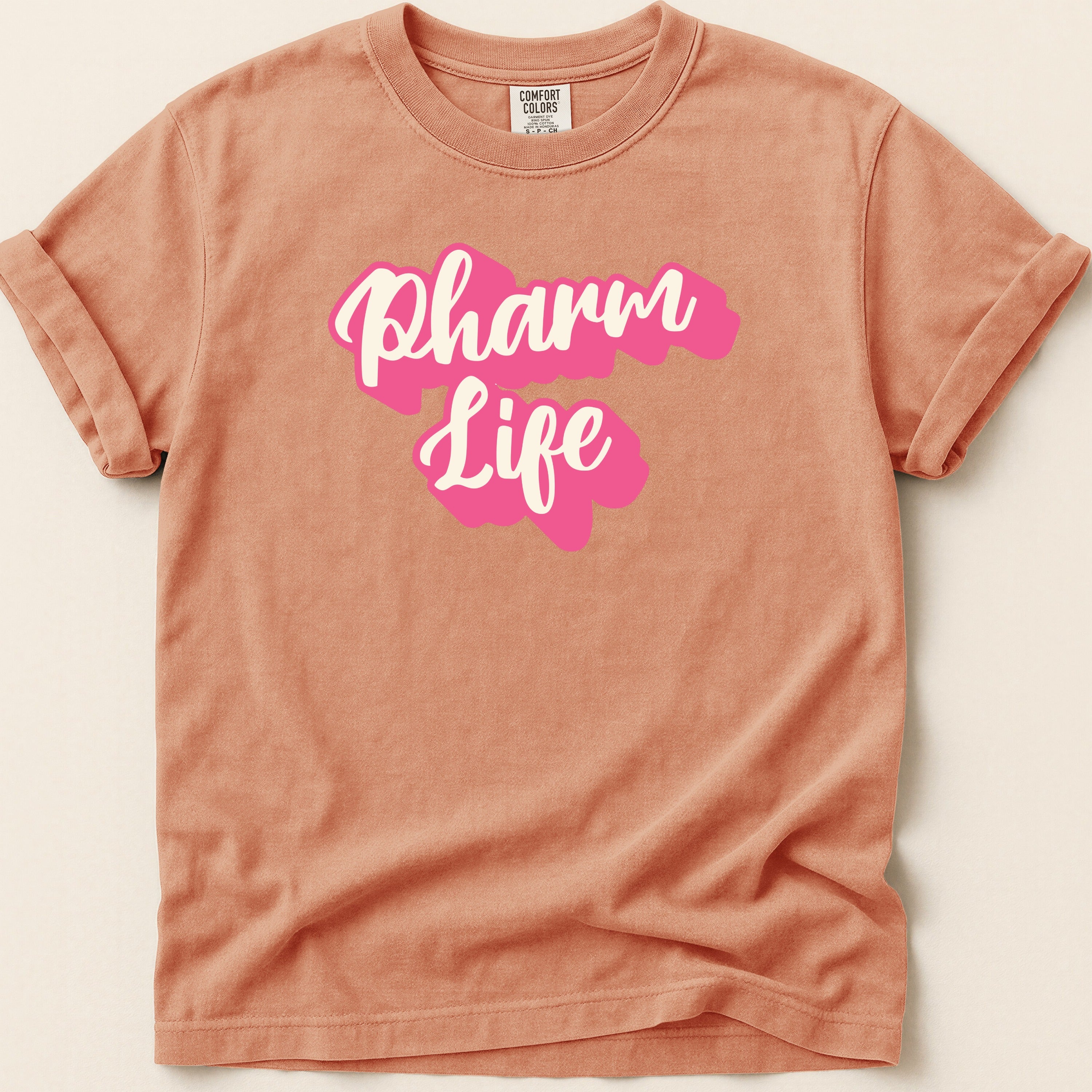 Peach t-shirt with "Pharm Life" text in pink script.