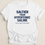 White t-shirt with navy text reading "SALTIER THAN HYPERTONIC SALINE 3% IS JUST THE START".