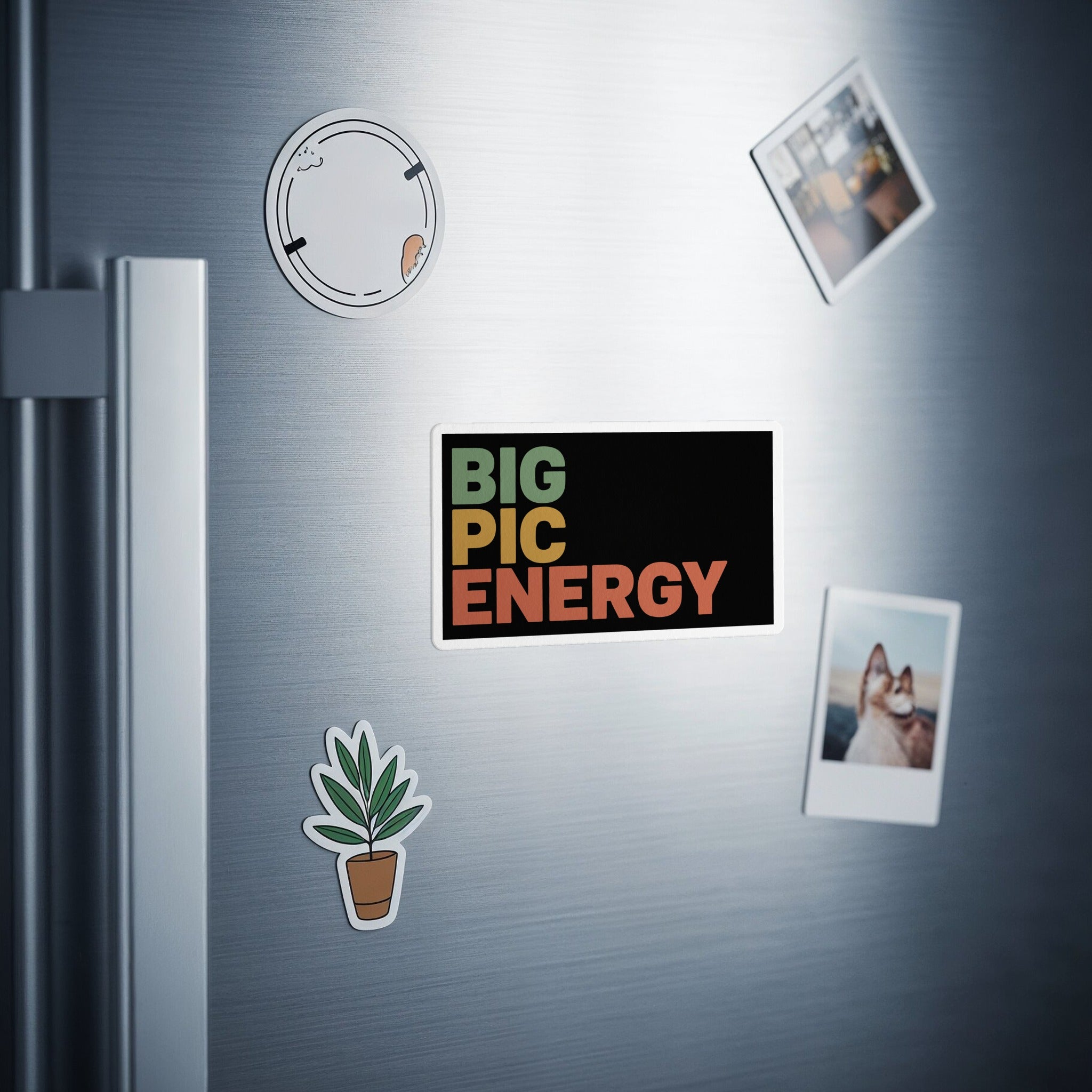 Black magnet with "BIG PIC ENERGY" in colorful text, two photos, and a plant sticker.
