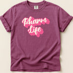 Purplish-pink t-shirt with "Pharm Life" in stylized pink lettering.