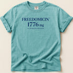 Teal t-shirt with "FREEDOMICIN 1776 mg As Needed for Patriotism" text.