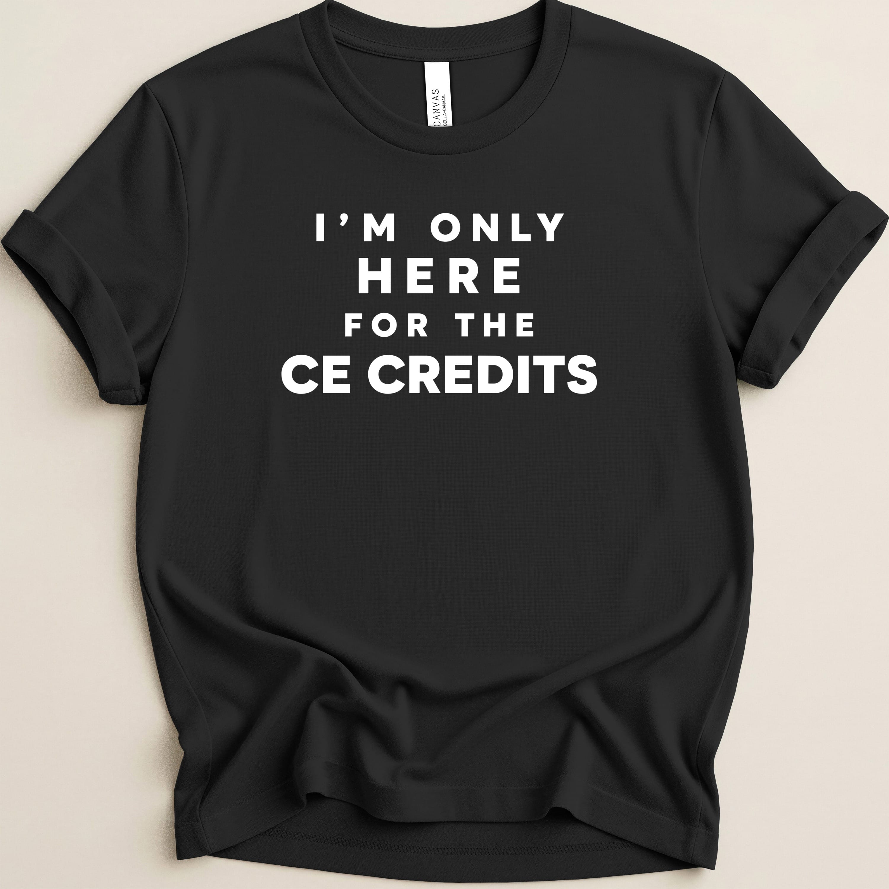 Black t-shirt with "I'M ONLY HERE FOR THE CE CREDITS" in white text.