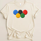Cream t-shirt with Olympic rings design and Bella+Canvas tag.
