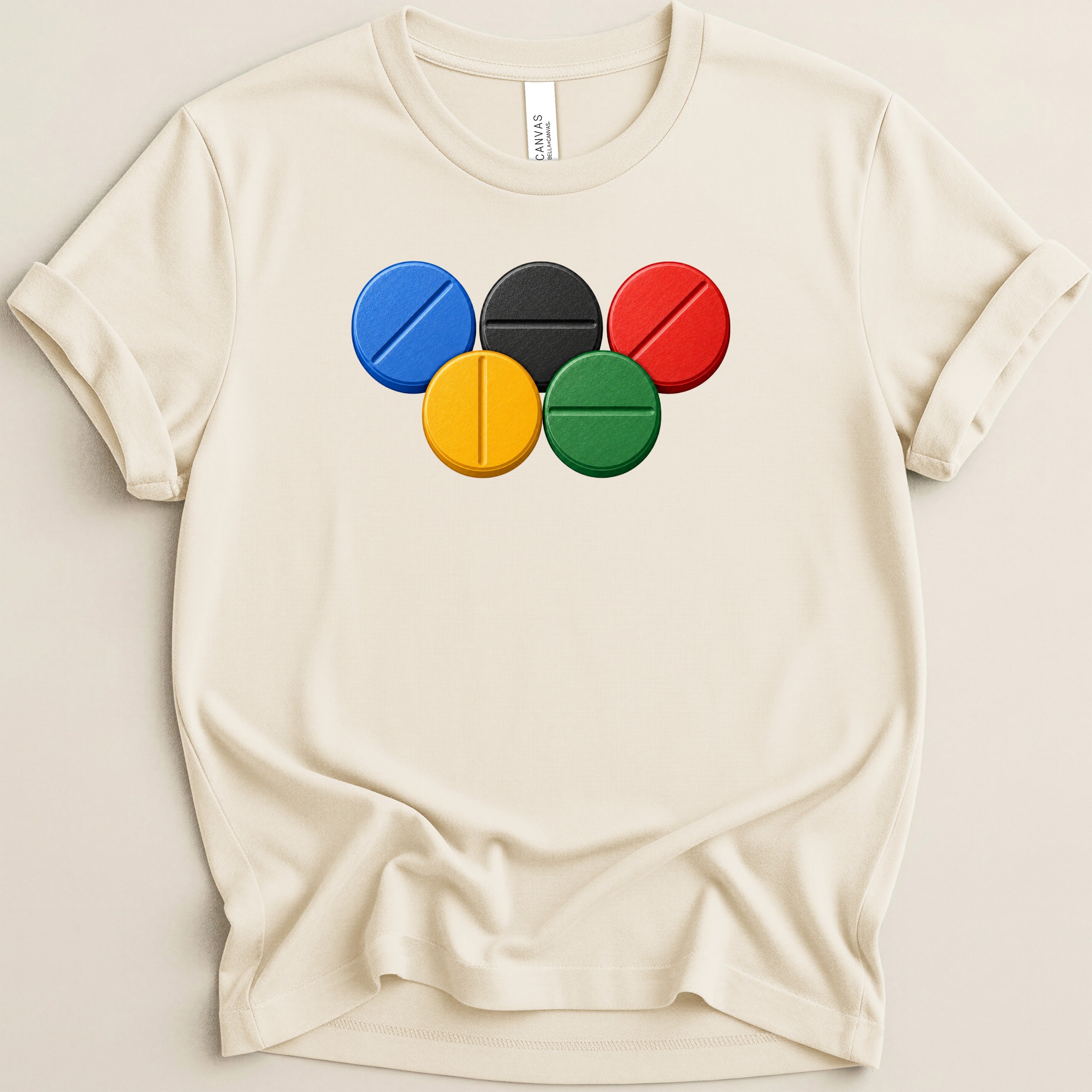 Cream t-shirt with Olympic rings design and Bella+Canvas tag.