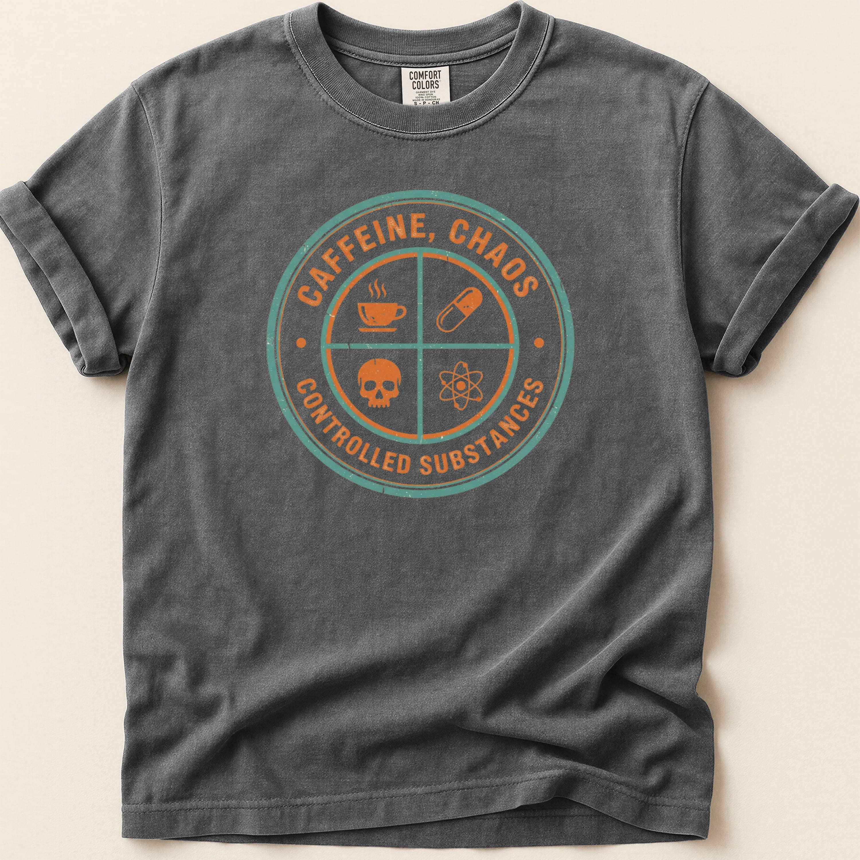 Dark grey t-shirt with circular "CAFFEINE, CHAOS CONTROLLED SUBSTANCES" graphic.