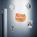 "Pharmacy" sticker with flowers, alongside a potted plant and two photos on a refrigerator.