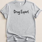 Gray t-shirt with black text "Drug Expert" printed on it.