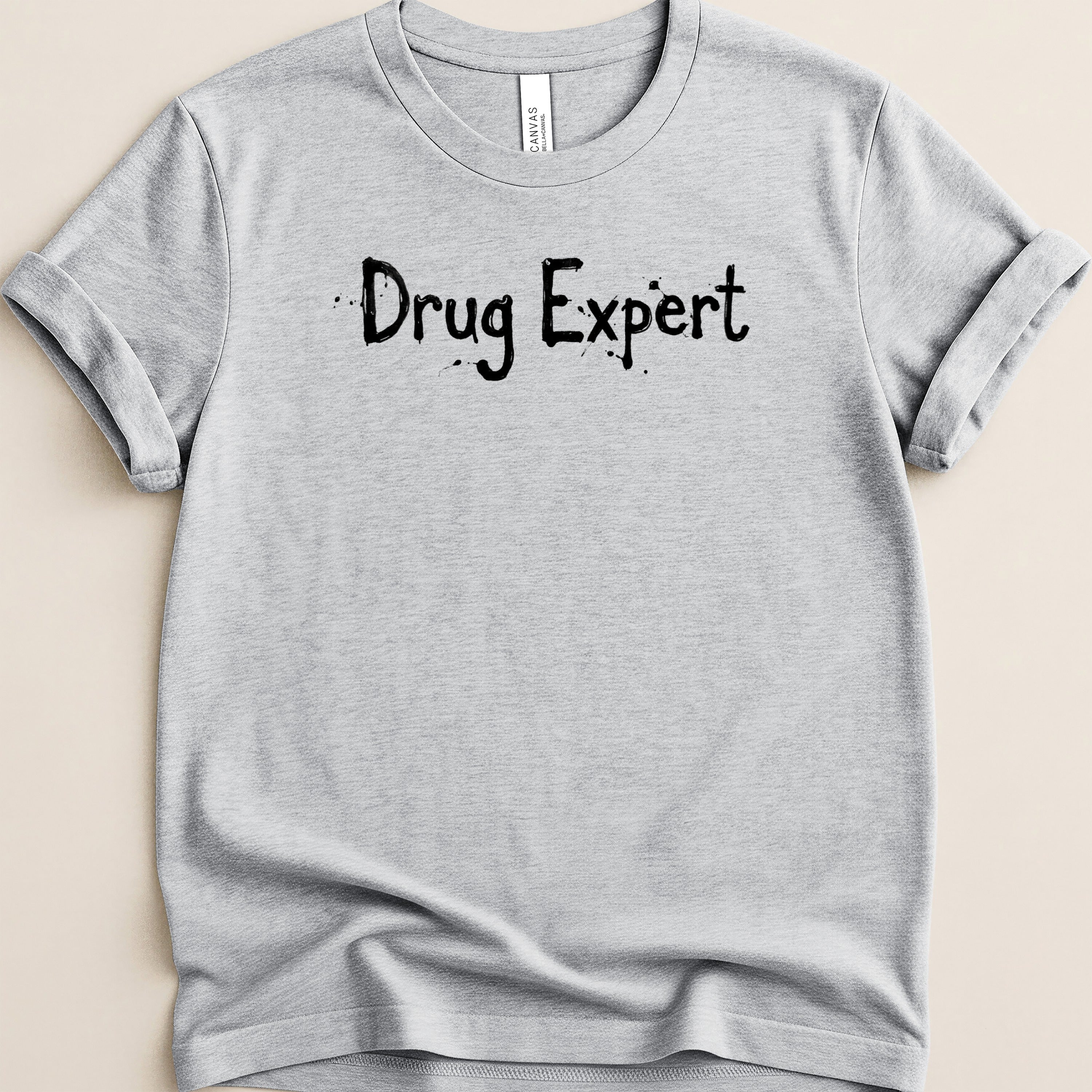 Gray t-shirt with black text "Drug Expert" printed on it.