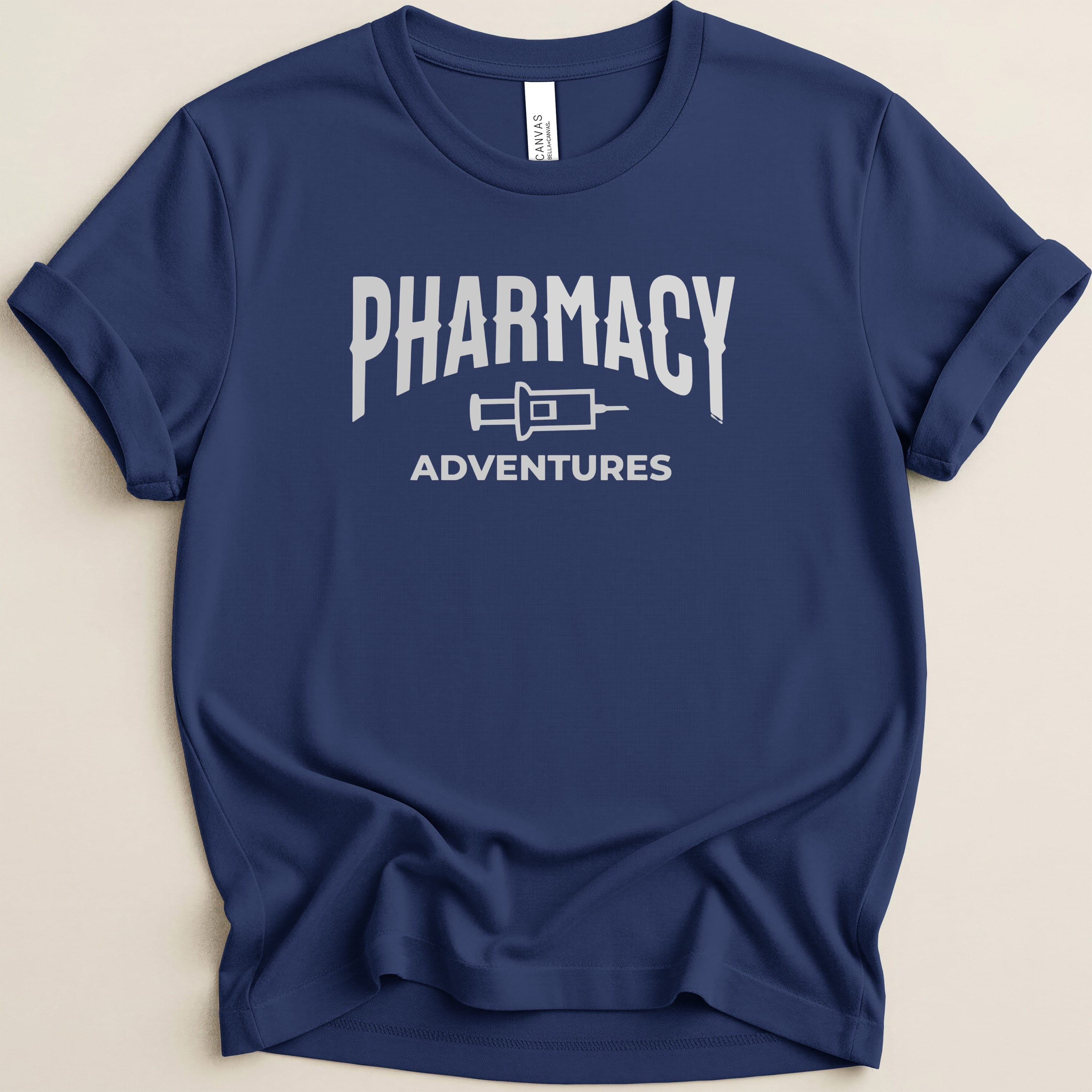Navy t-shirt with "Pharmacy Adventures" logo in white text.