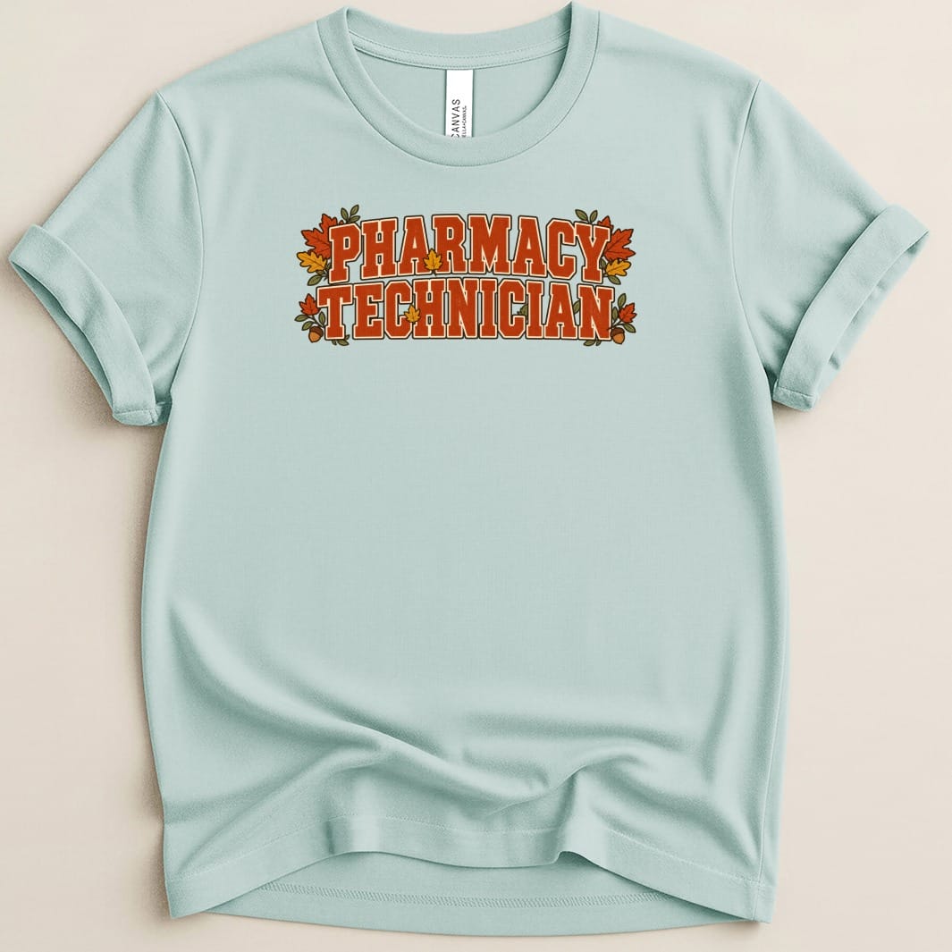 A light blue t-shirt featuring a retro-style autumn graphic with the text PHARMACY TECHNICIAN surrounded by leaves and acorns.