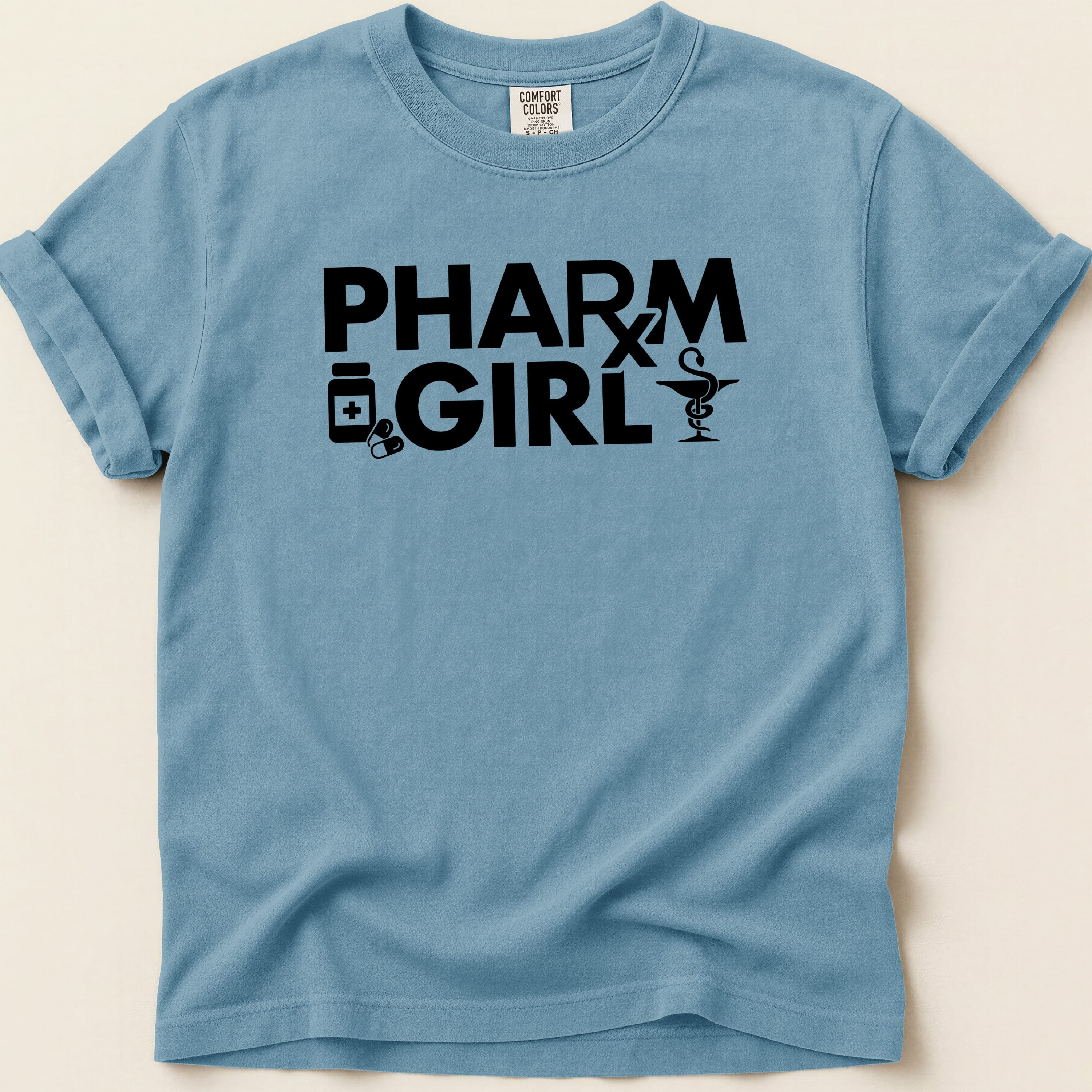 Blue t-shirt with "PHARM GIRL" text and medical icons.