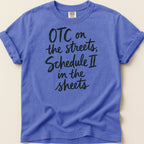 Purple t-shirt with "OTC on the streets, Schedule II in the sheets" in black script.