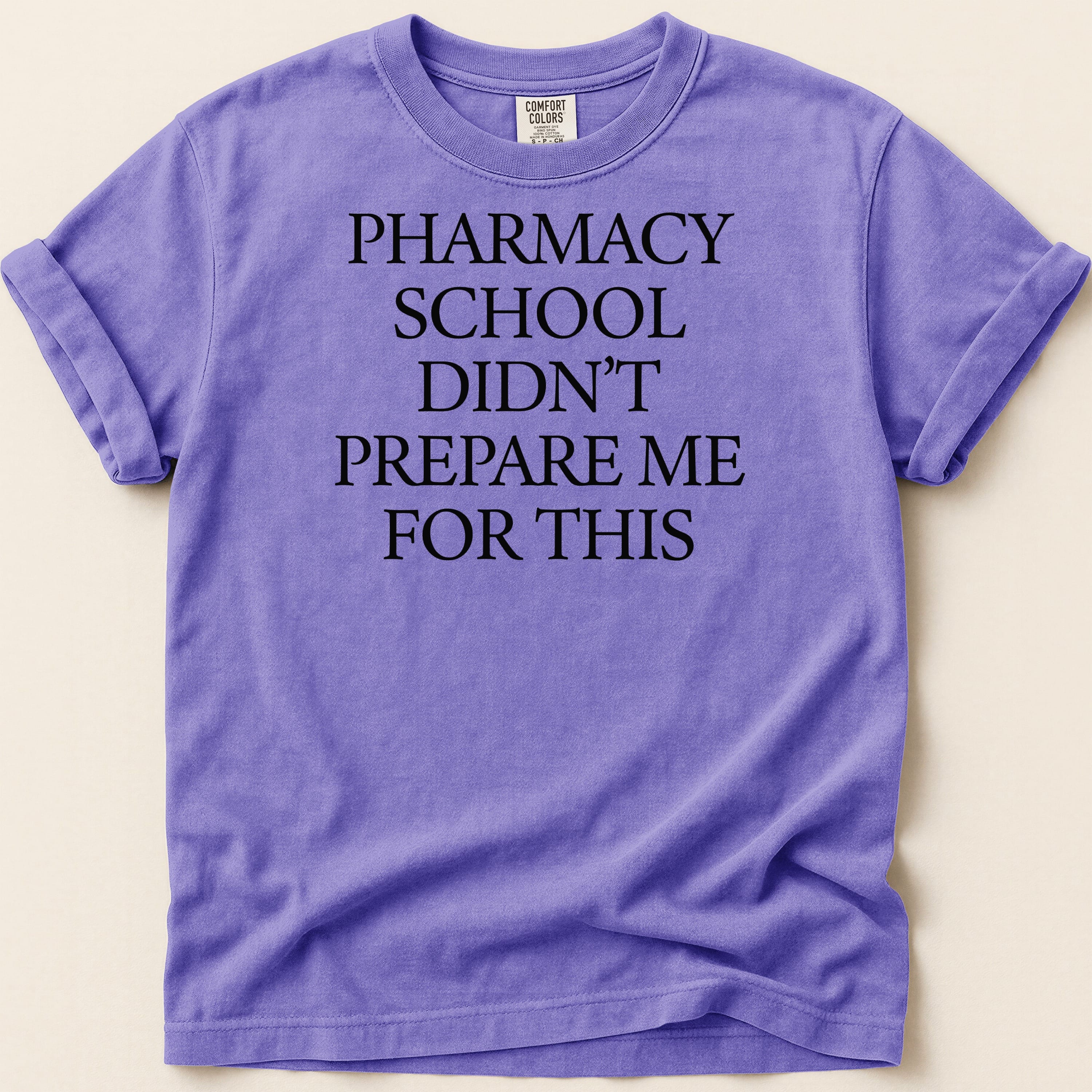 Purple t-shirt with "Pharmacy school didn't prepare me for this" text.