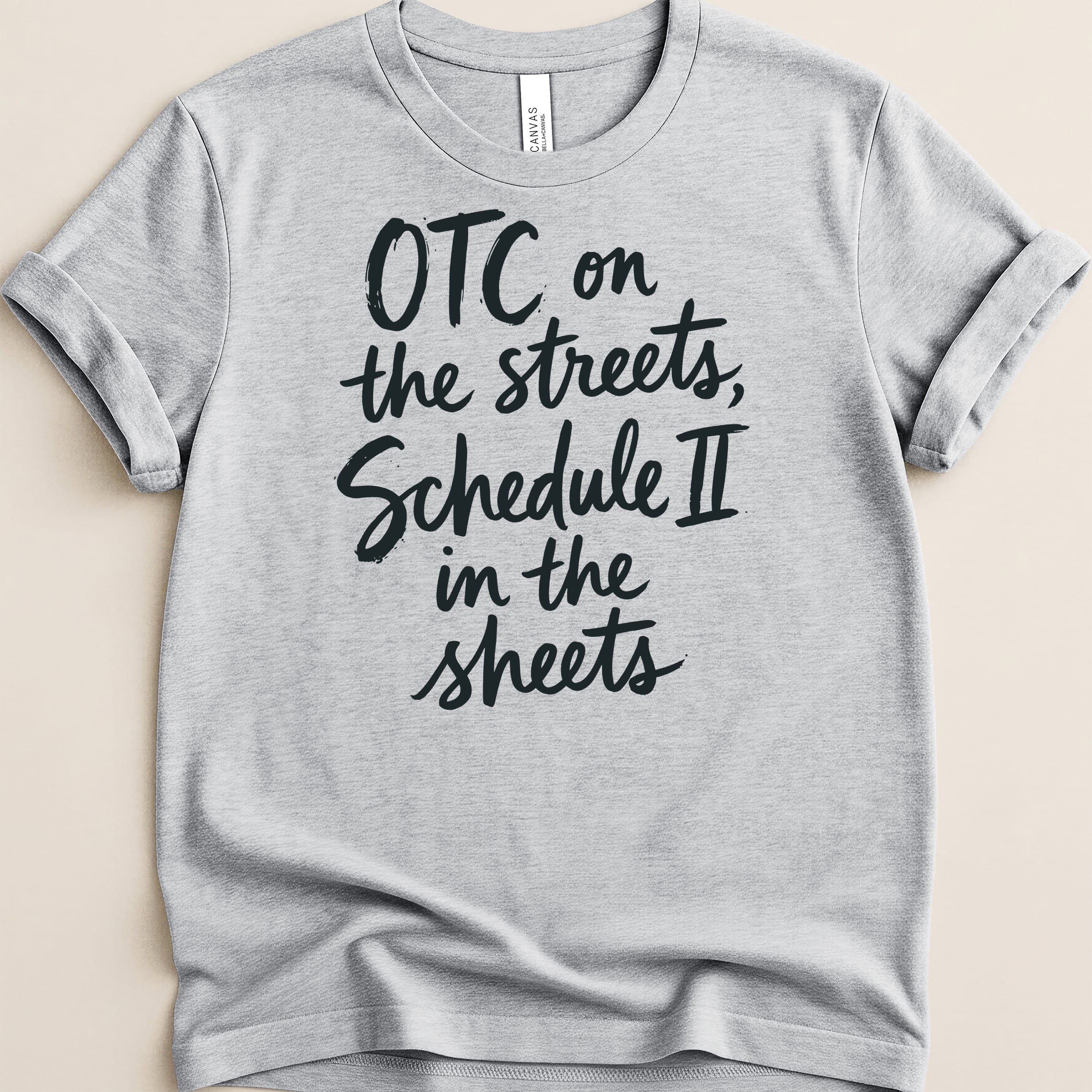 Gray t-shirt with black text "OTC on the streets, Schedule II in the sheets."