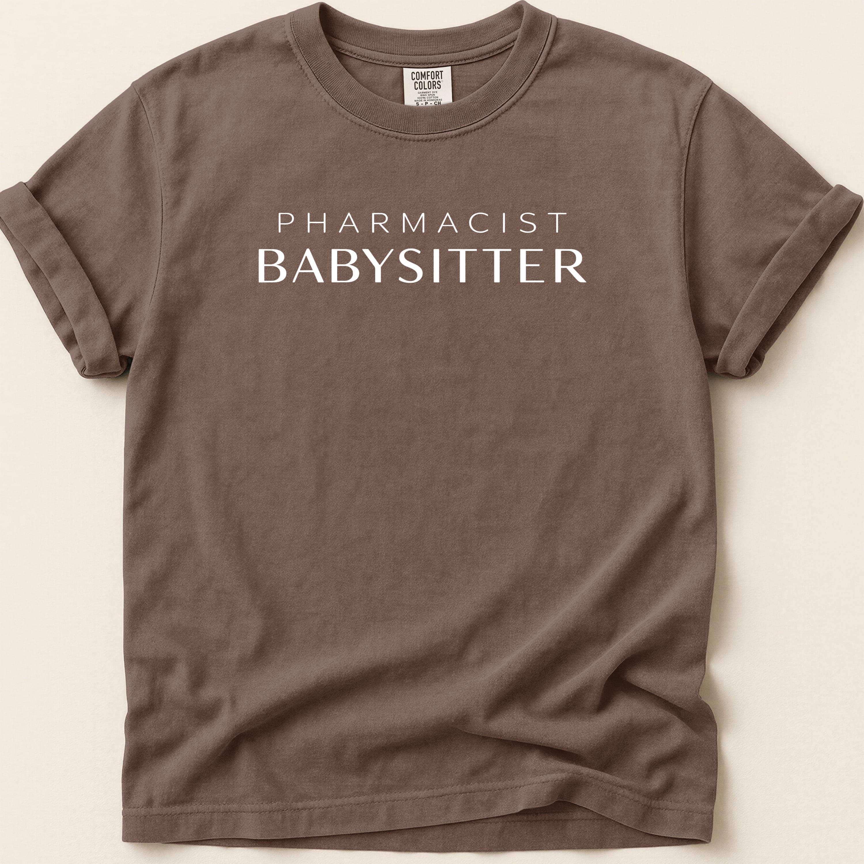 Brown t-shirt with "Pharmacist Babysitter" printed in white.