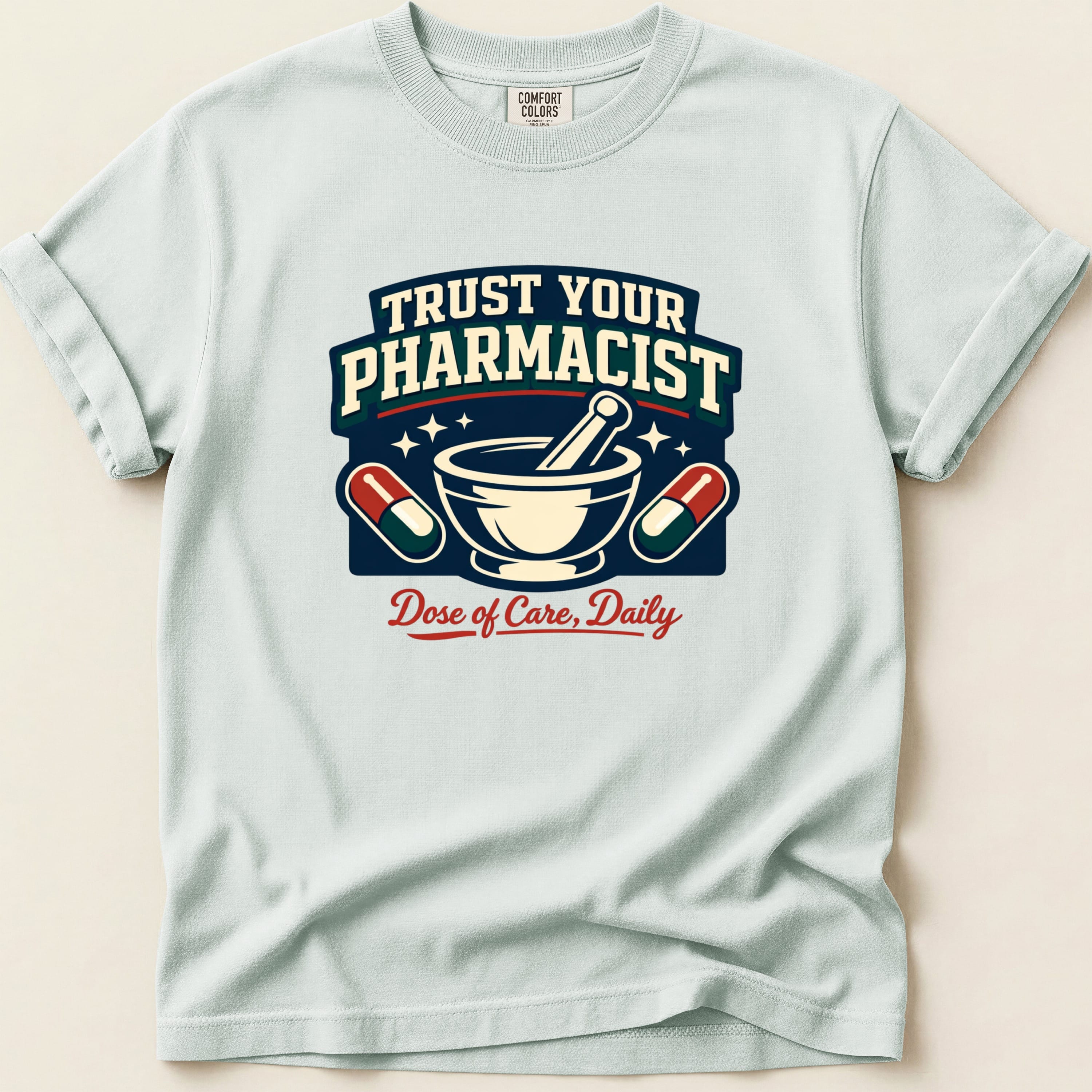 Light blue t-shirt with "Trust Your Pharmacist Dose of Care, Daily" graphic.