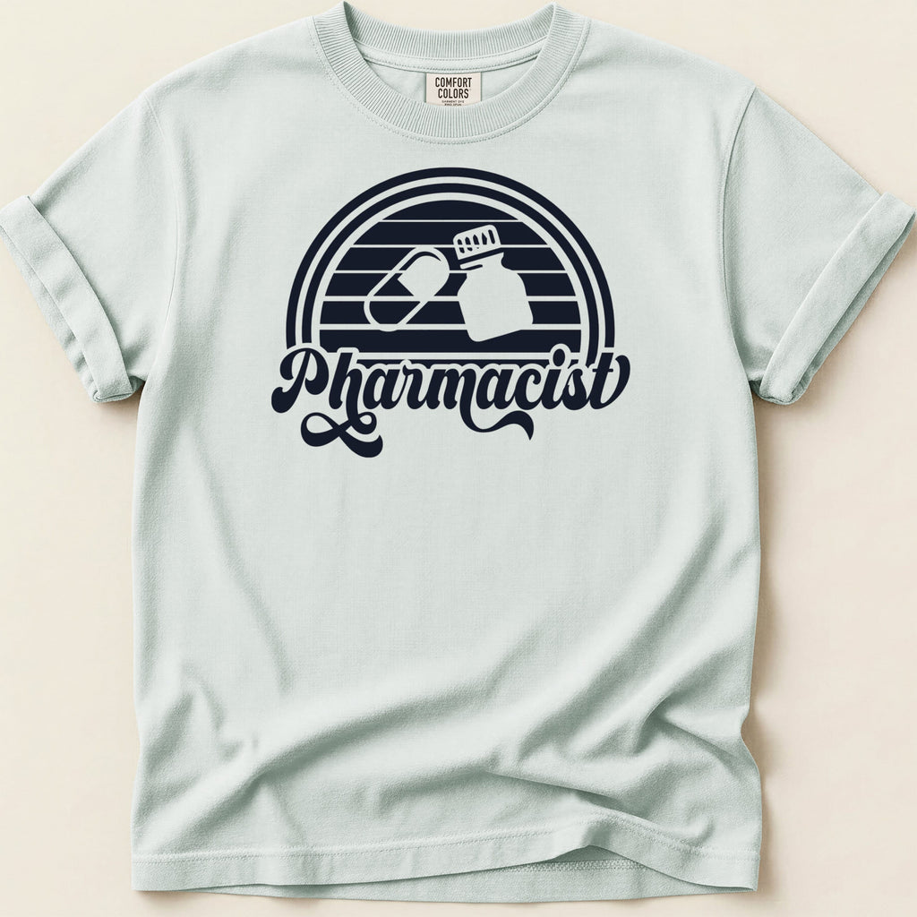 Light blue t-shirt with black "Pharmacist" text and pill capsule and bottle graphic.