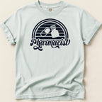 Light blue t-shirt with black "Pharmacist" text and pill capsule and bottle graphic.