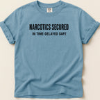 Blue t-shirt with "NARCOTICS SECURED IN TIME-DELAYED SAFE" text.