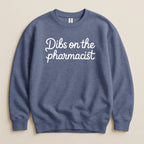 Blue Gildan sweatshirt with "Dibs on the pharmacist" text in white script.