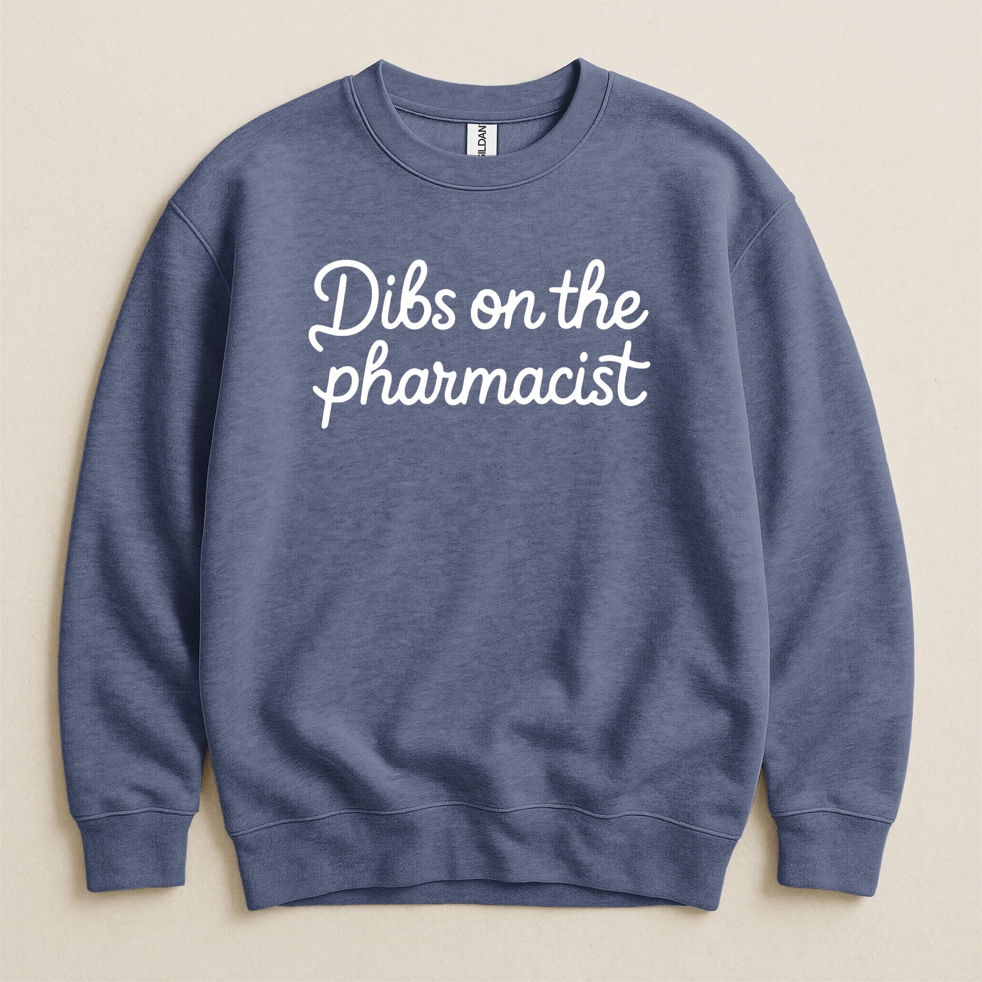 Blue Gildan sweatshirt with "Dibs on the pharmacist" text in white script.