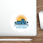Sticker with a cartoon pharmacy building under a smiling sun and clouds.