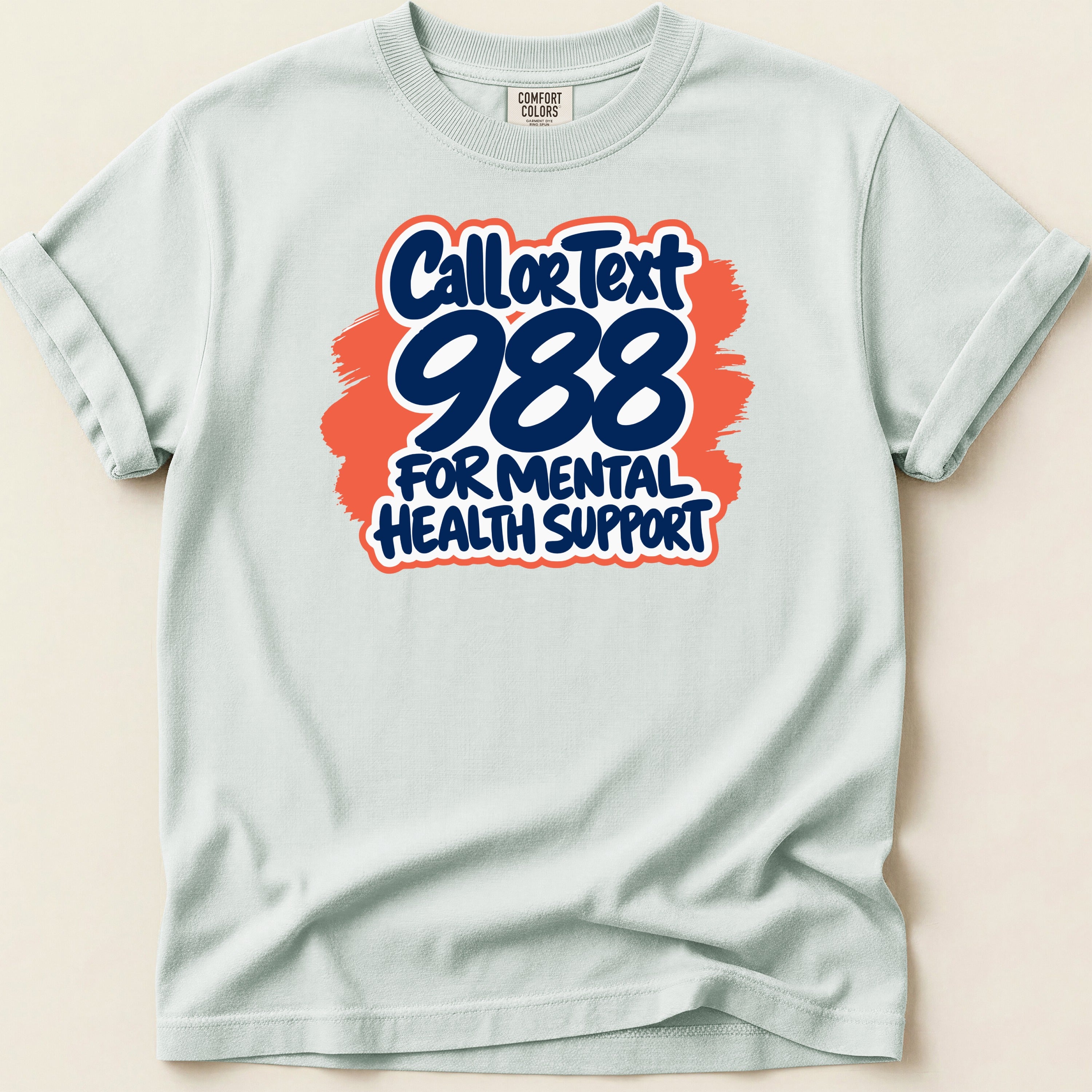 Light blue t-shirt with text "Call or Text 988 for Mental Health Support."