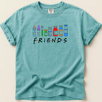 Teal t-shirt with "FRIENDS" in colorful medical vials and bottles.
