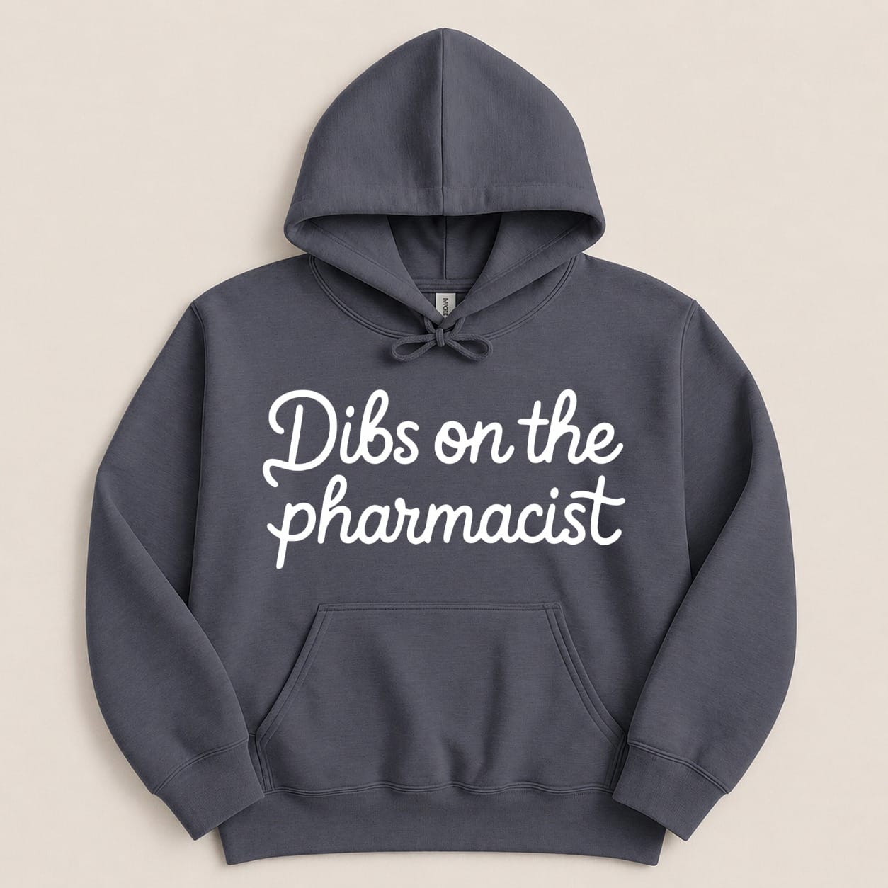 Dark gray hoodie with white cursive text "Dibs on the pharmacist".