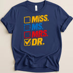 Navy t-shirt with distressed yellow, blue, and red text: Miss, Ms, Mrs, Dr.