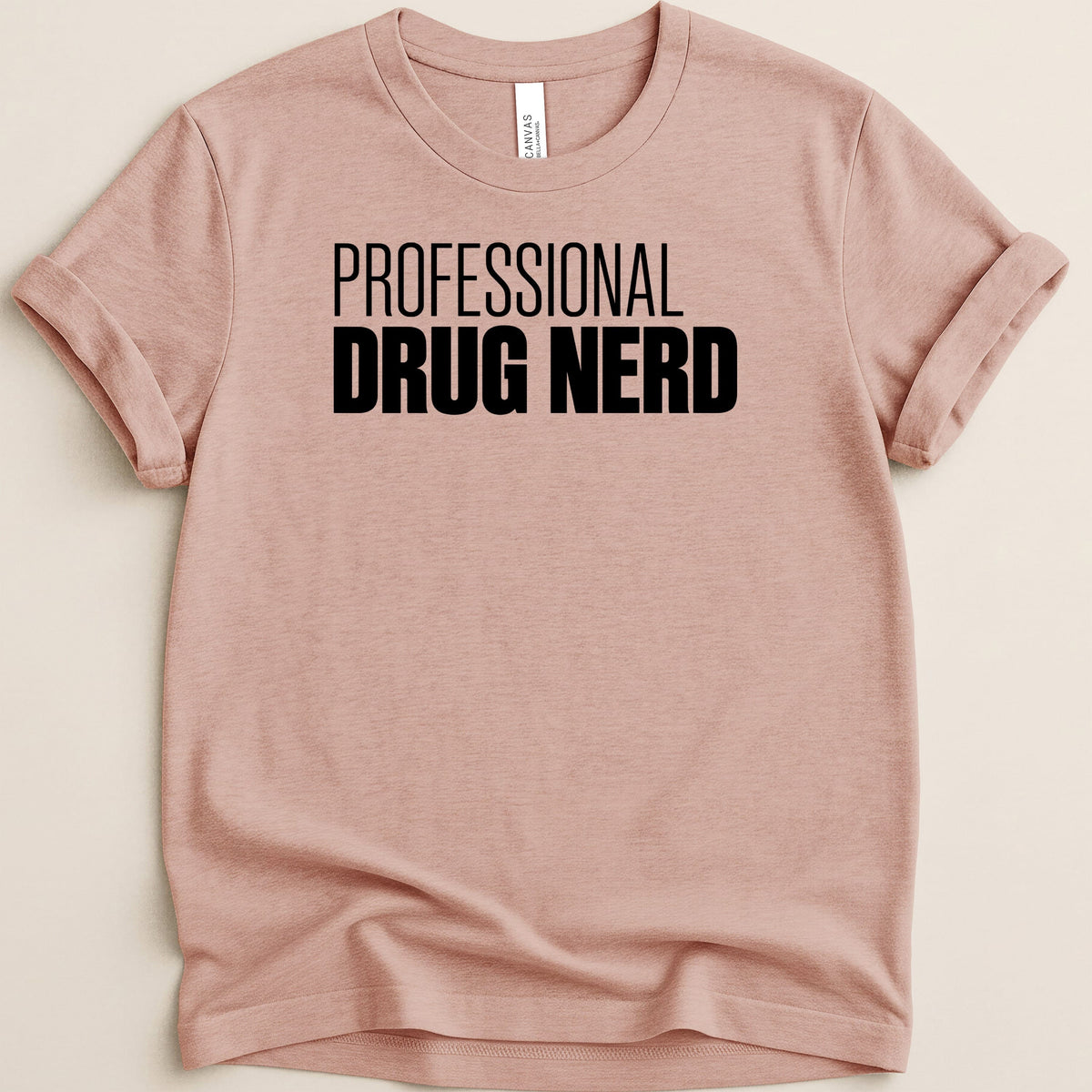 Pink t-shirt with black text reading "PROFESSIONAL DRUG NERD".