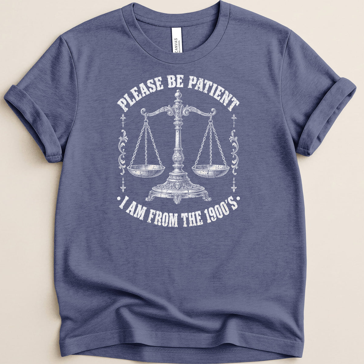 Blue t-shirt with white text and a vintage balance scale graphic.